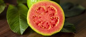 photo of Beautiful fresh red guava, autumn fruit on wooden rustic background