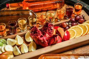 photo of pomegranate lemon lime apple grape and orange charcuterie with beer flight