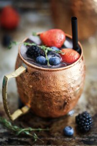 photo of copper beer mug with berries photo
