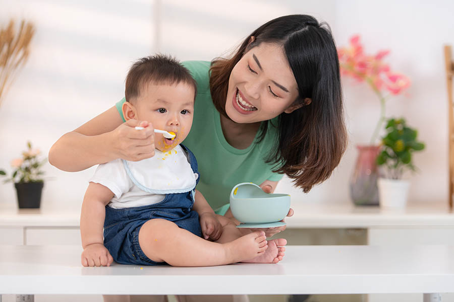 Mom and babys breakfast time | Puree Arete photo of mom feeding baby healthy food