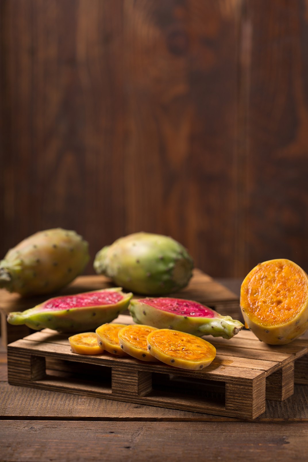 cactus fruit over wooden background | Puree Arete fresh cut prickly pear photo
