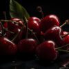 Fresh juicy cherry isolated on a black background | Puree Arete Photo of Dark Sweet cherry puree