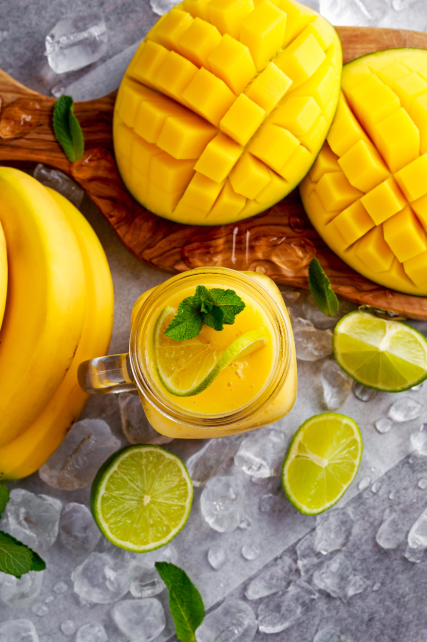 Healthy ripe fruits Smoothie with slices of Lime mint and ice | Puree Arete summer mango for beverages photo