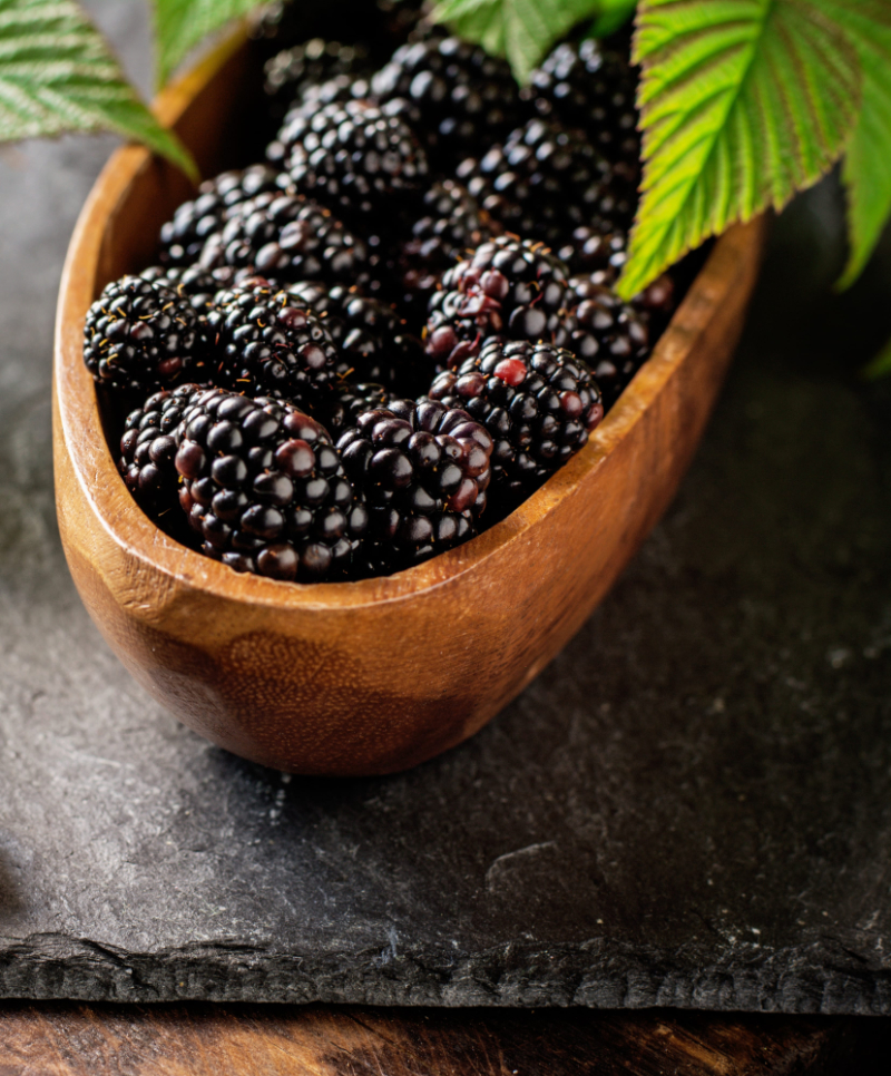 Fresh blackberries in wooden bowl Selective focus | Puree Arete Blackberry flavor pairings for new food and beverage product development