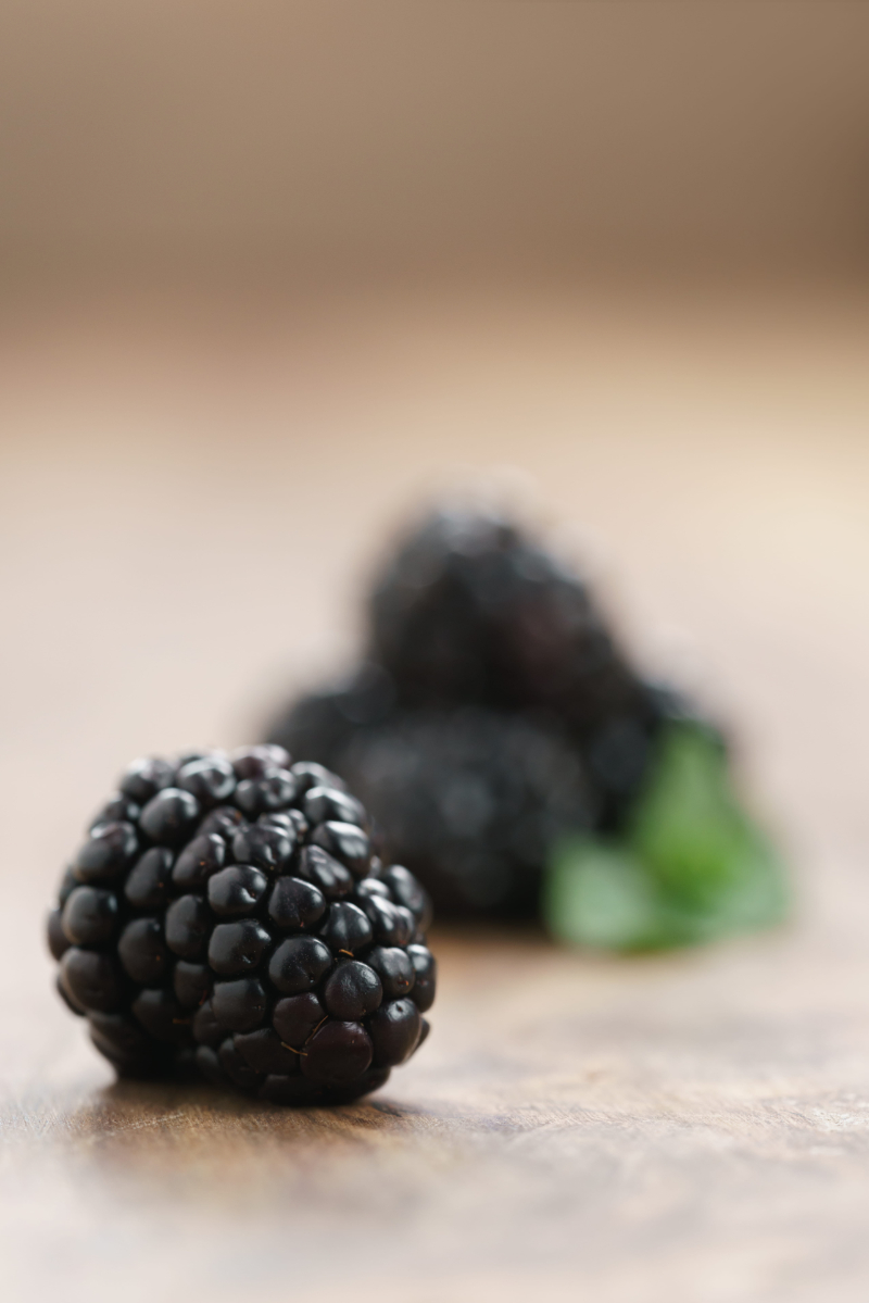 closeup photo of fresh blackberry on old wood table shallow focus | Puree Arete Blackberry fruit purée for commercial food and beverage manufacturing